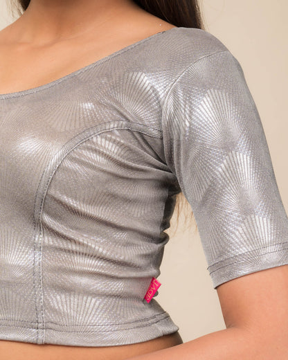 Close-up of the jacquard knit fabric with glittery metallic detailing.
