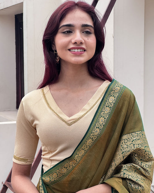 Model wearing a stretchable blouse with elbow sleeves and a V-neckline featuring metallic sheen.