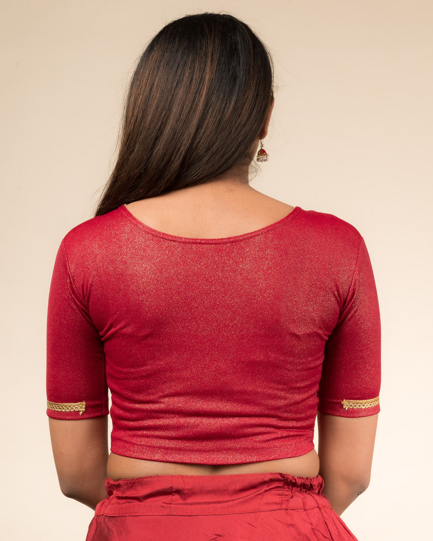 Rear view highlighting the blouse’s smooth back fit.