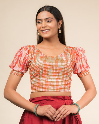 Model wearing a stretchable blouse with printed body, puff organza sleeves, and round neckline.
