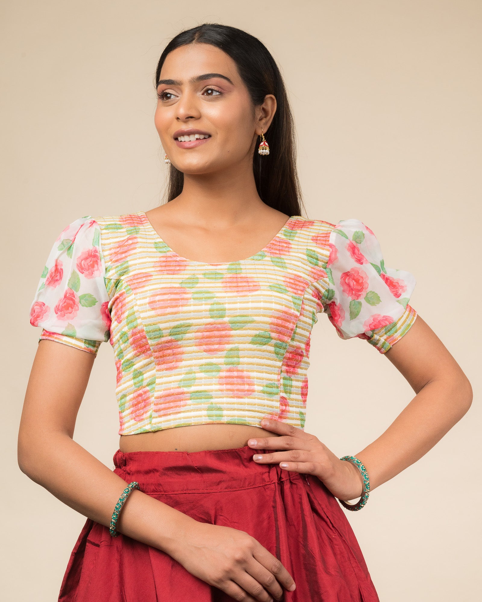 Model wearing a stretchable blouse with printed body, puff organza sleeves, and round neckline