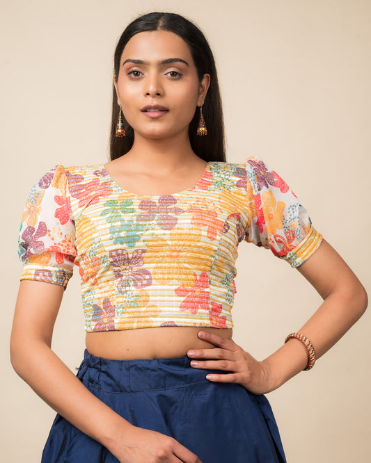 Model wearing a stretchable blouse with printed body, puff organza sleeves, and round neckline.