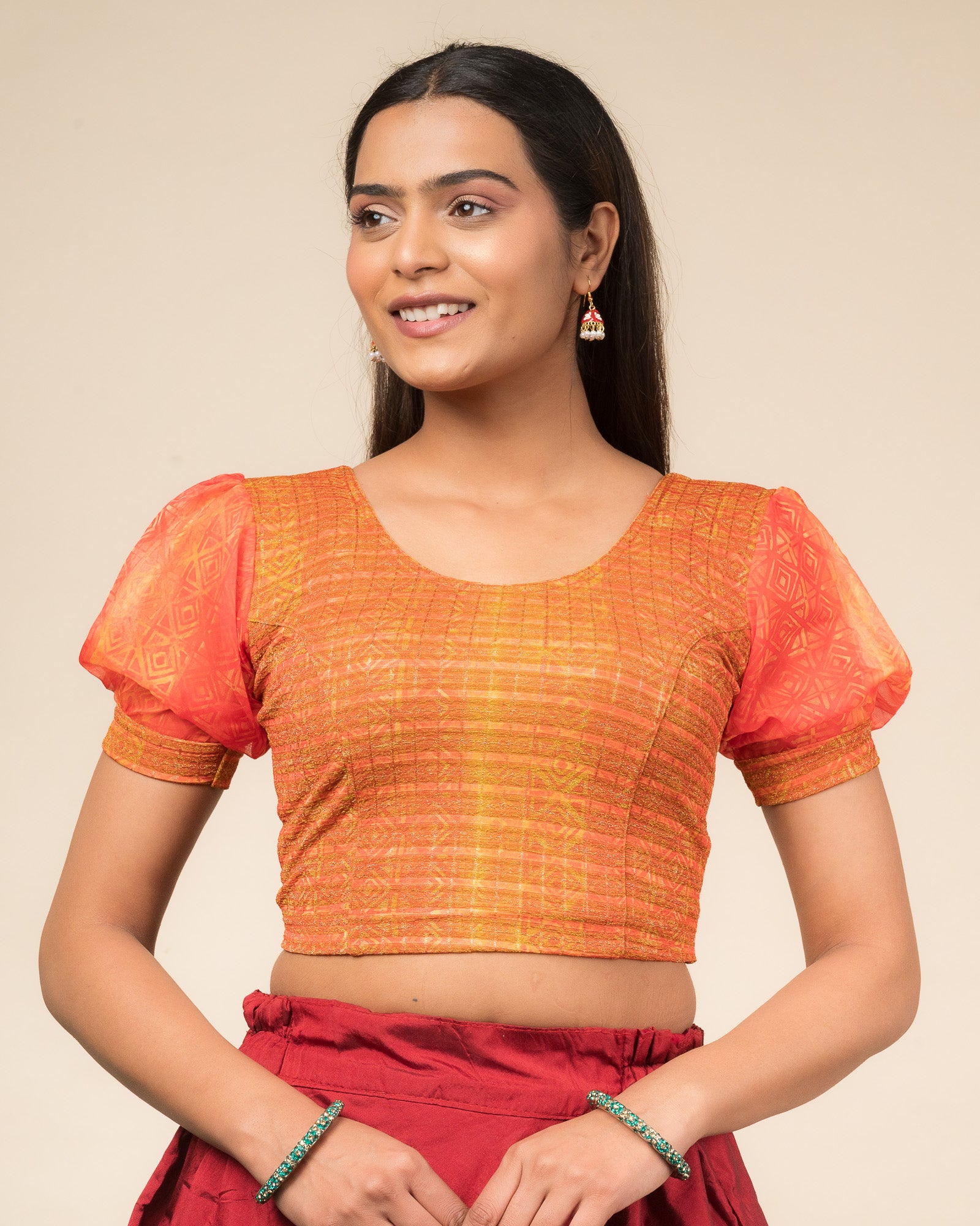 Model wearing a stretchable blouse with printed body, puff organza sleeves, and round neckline.