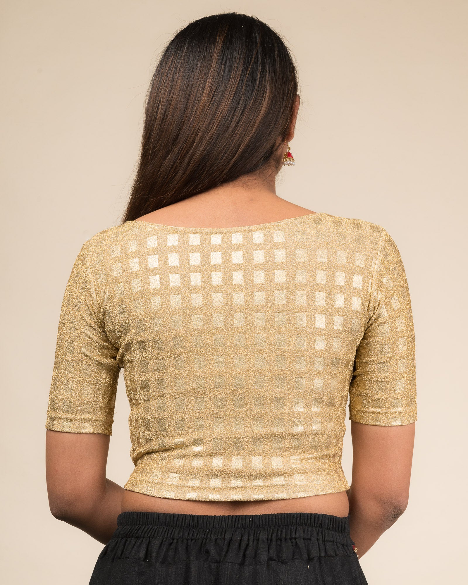 Rear view showcasing the blouse’s clean boat-neck back and fit.