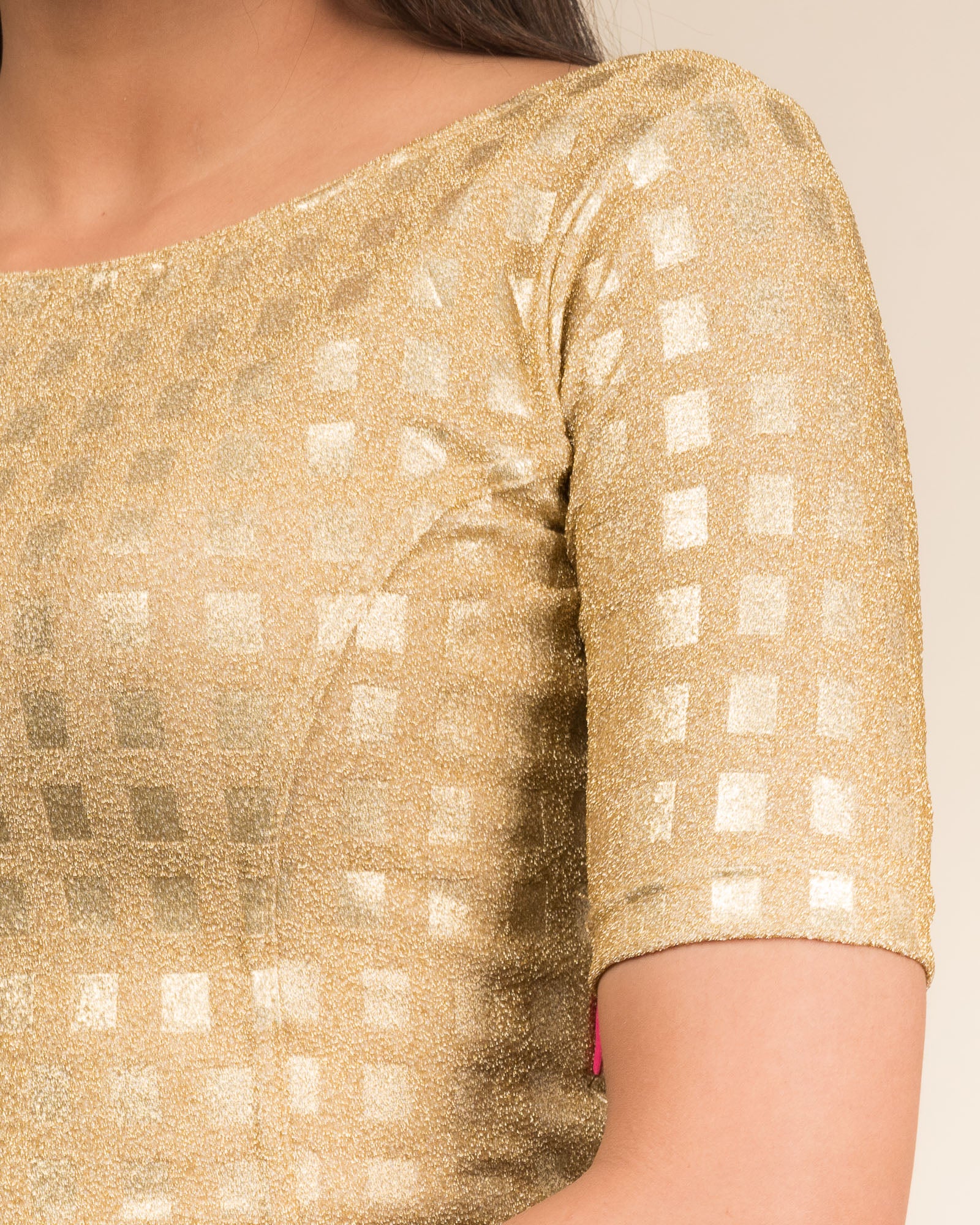 Close-up of the jacquard texture with metallic check embossing.