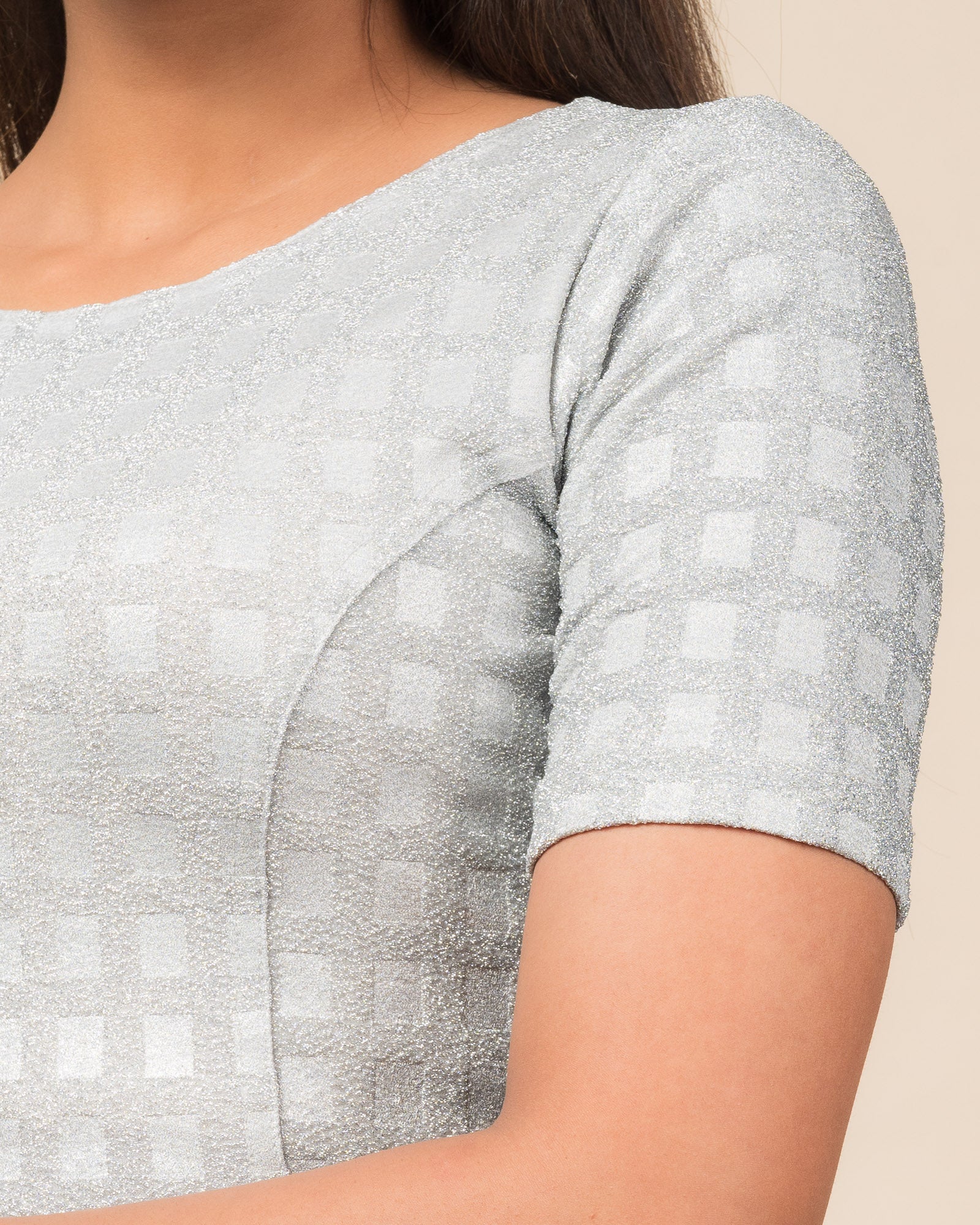 Close-up of the jacquard texture with metallic check embossing.