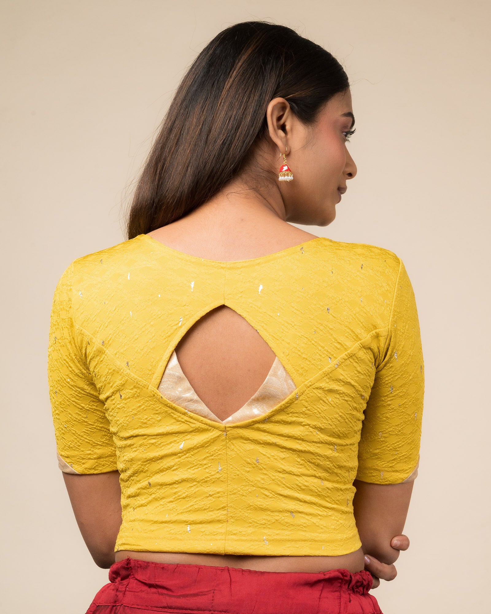Rear view showcasing the artistically cut designer back design.
