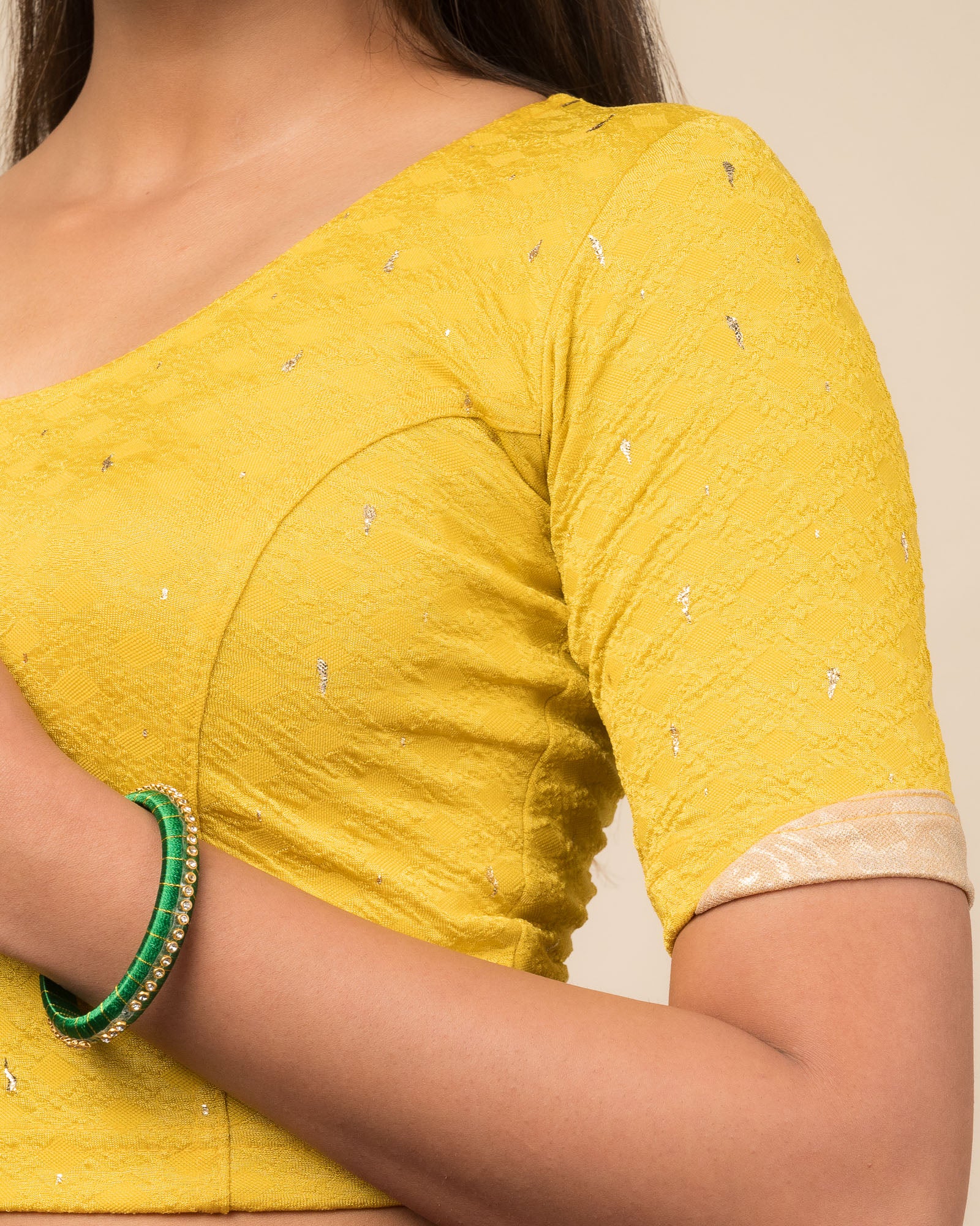 Close-up showing jacquard fabric with metallic drop accents.