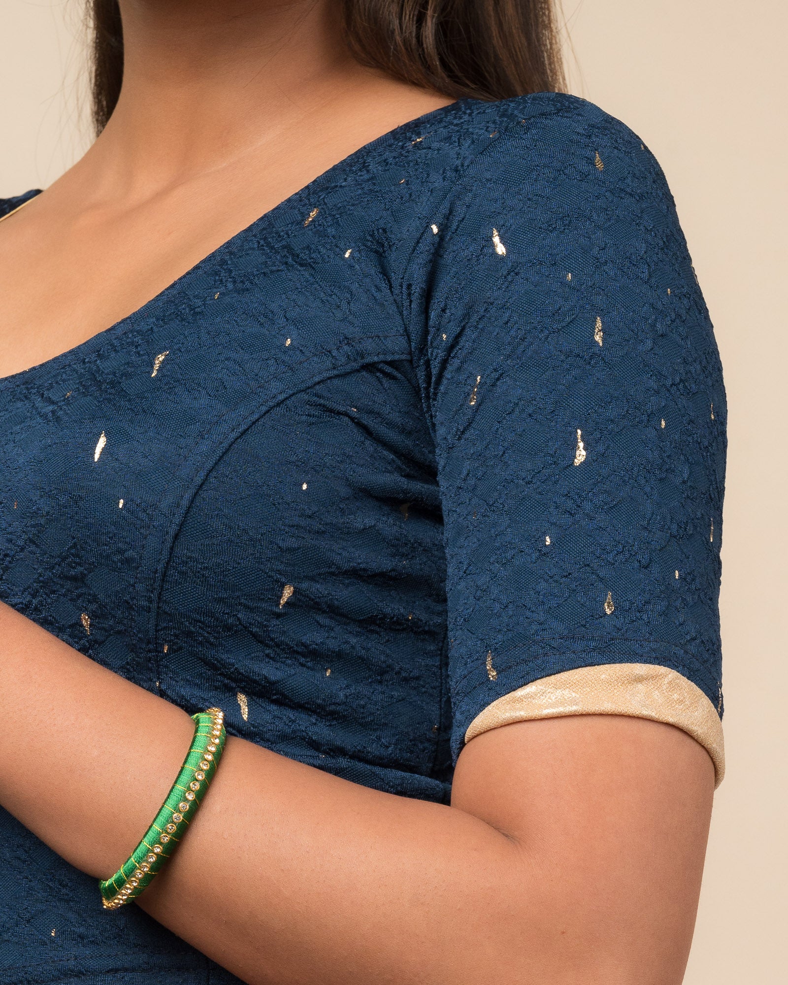 Close-up showing jacquard fabric with metallic drop accents.