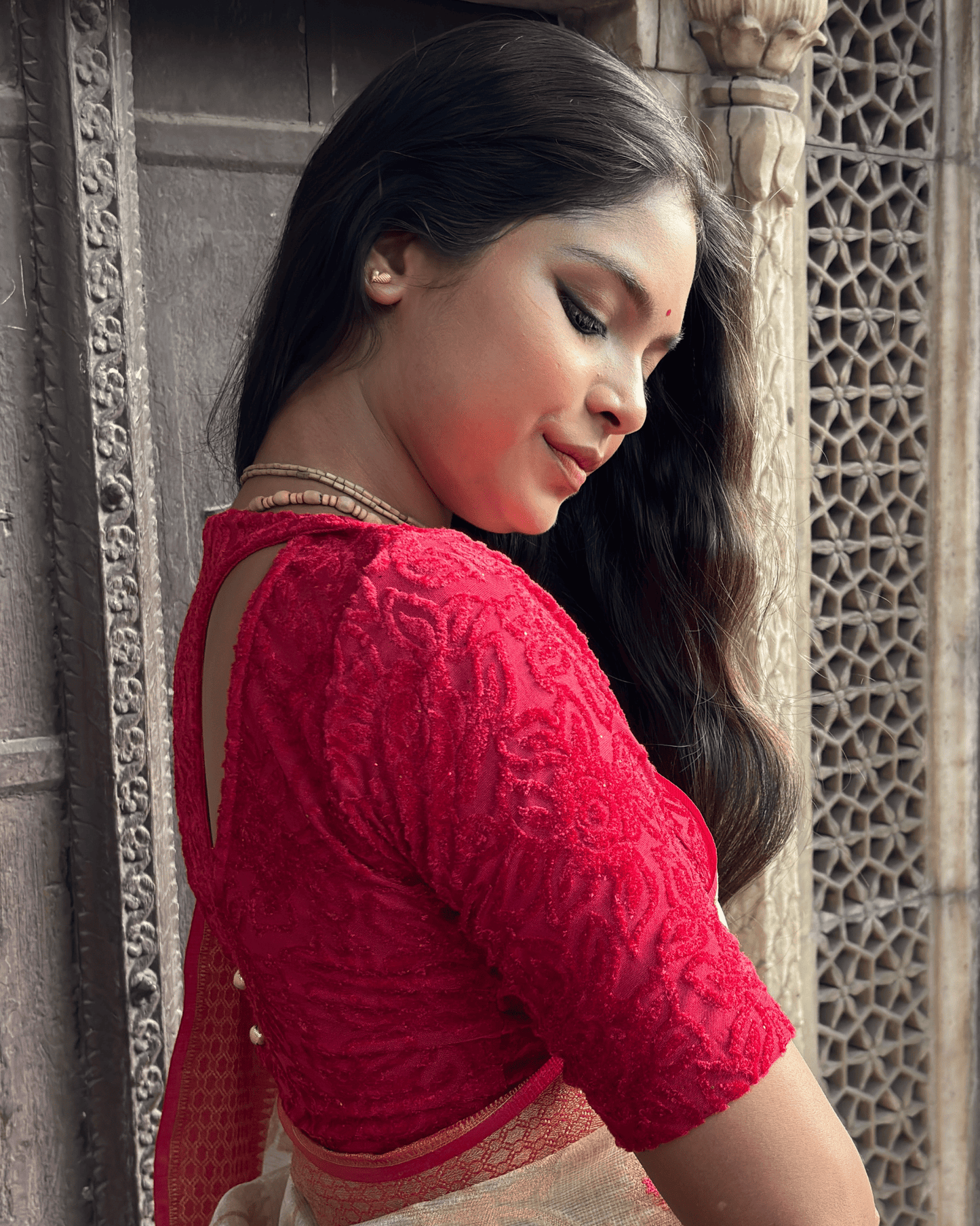 Side profile of the tone-sparkle stretchable blouse highlighting the fit and back detailing.