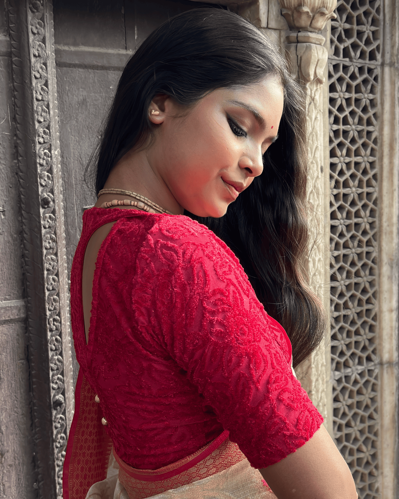 Side profile of the tone-sparkle stretchable blouse highlighting the fit and back detailing.