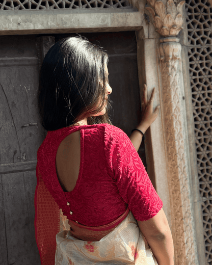 Rear view of the tone-sparkle stretchable blouse showcasing the designer back cut with potli buttons.