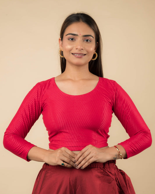 Model wearing a stretchable dobby-weave cotton blouse with long sleeves and round neckline