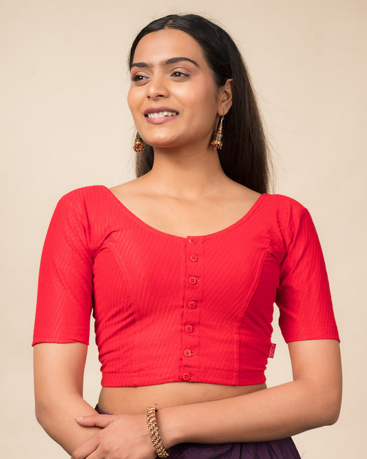 Model wearing a stretchable dobby-weave cotton blouse with elbow sleeves, round neckline, and front-button closure