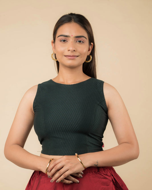 Model wearing a sleeveless stretchable cotton blouse with high neckline