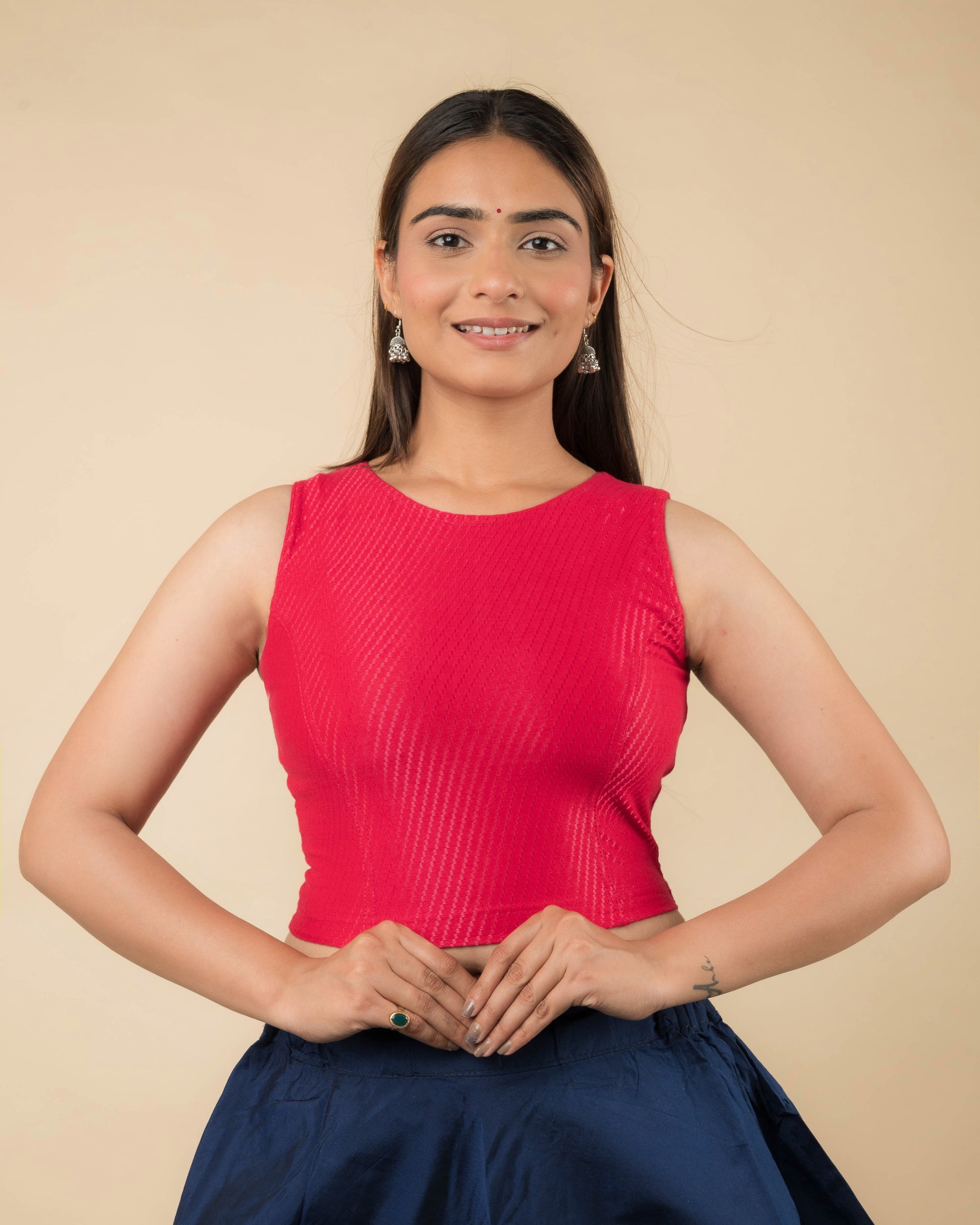 Model wearing a sleeveless stretchable cotton blouse with high neckline