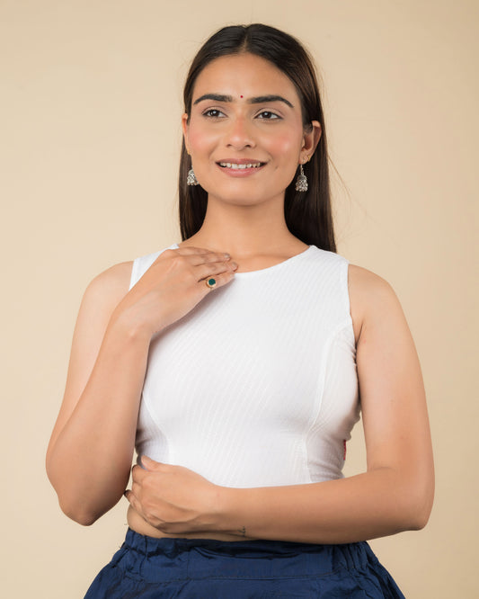Model wearing a sleeveless stretchable cotton blouse with high neckline