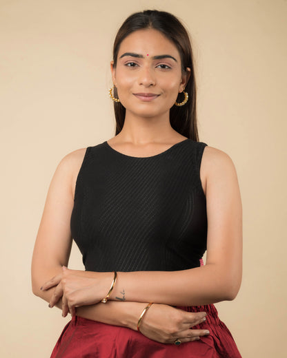 Model wearing a sleeveless stretchable cotton blouse with high neckline