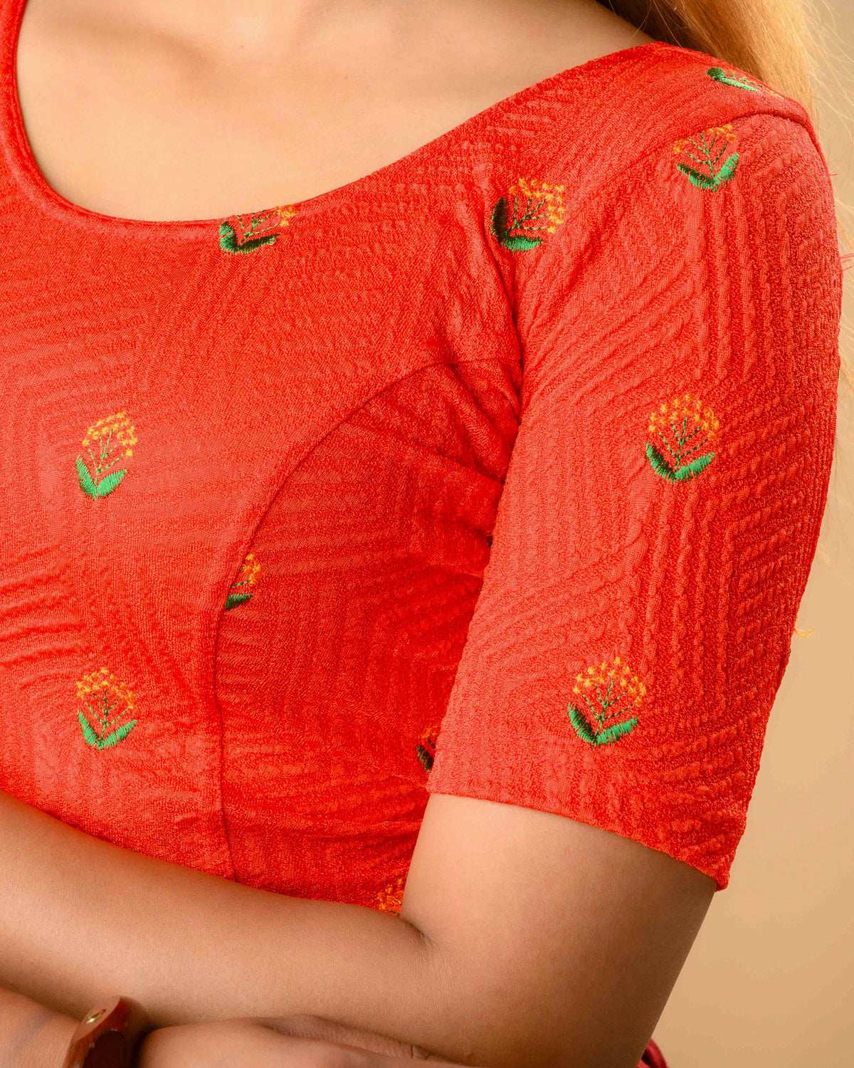 Close up of orange and green resham buti on Keerti Red jacquard blouse by Advi - detail