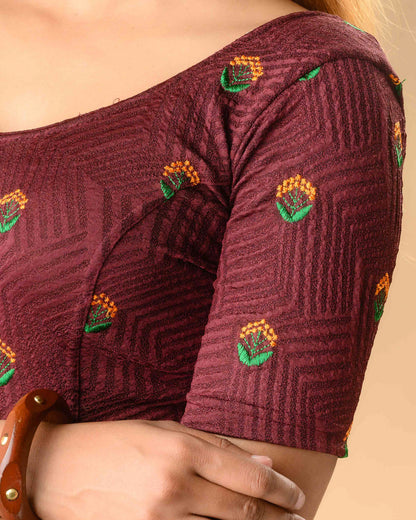 Close up of orange and green resham buti on Keerti Wine jacquard blouse by Advi - detail