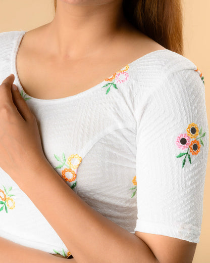Close up of resham flowers and mirror work on the Jheeni white blouse by Advi - detail