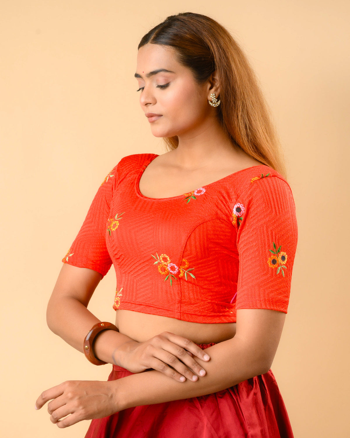 Jheeni red blouse side view with mirror work on the elbow sleeves by Advi - side