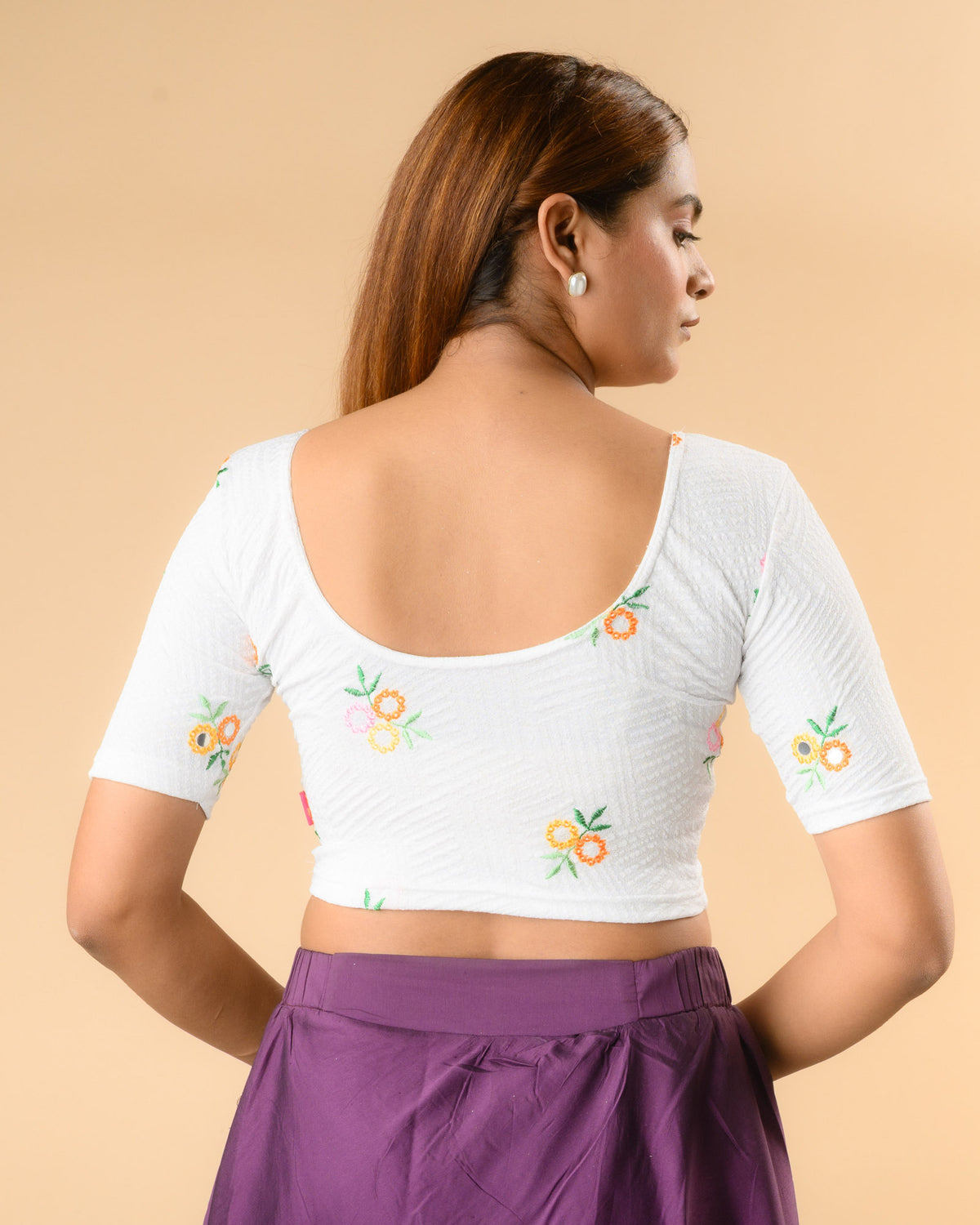 Jheeni white blouse showing the deep U back with floral buti by Advi - back