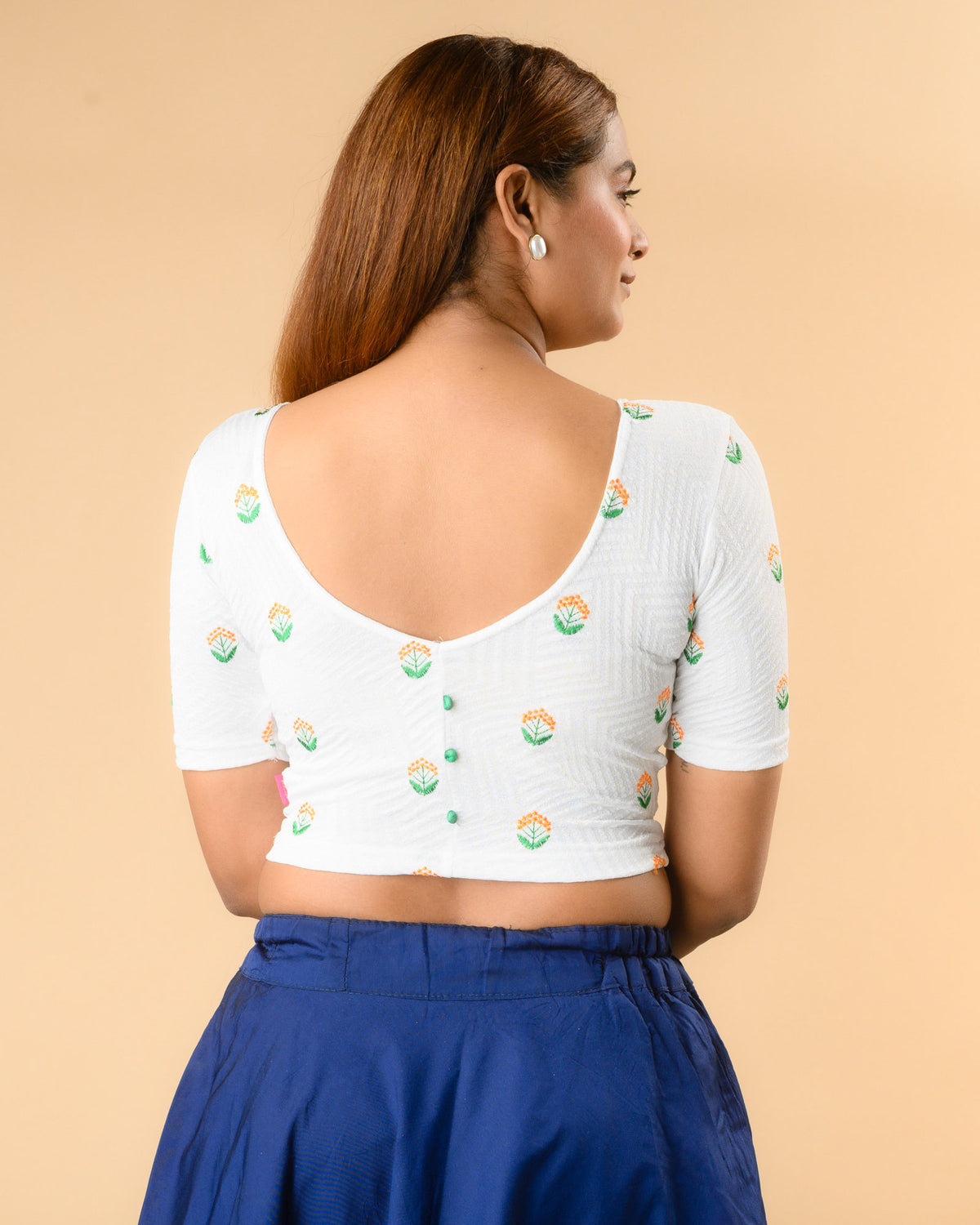 Keerti White Resham Buti blouse showing deep V back with green potli buttons by Advi - back