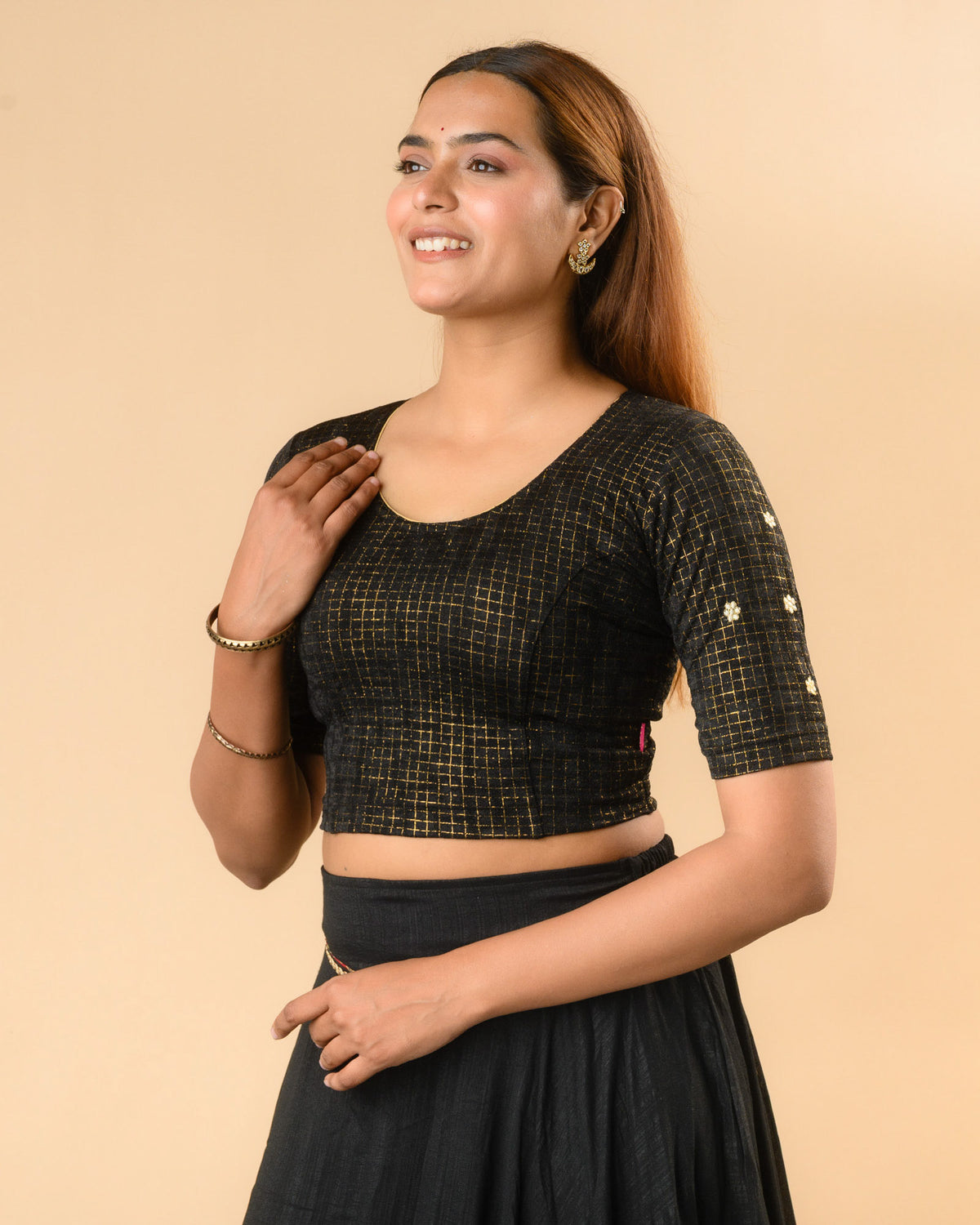 Yamini black blouse showing elbow sleeves with floral buti embroidery by Advi - side