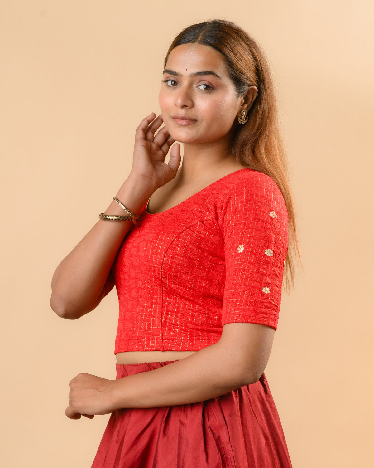Yamini dark red blouse showing elbow sleeves with floral buti embroidery by Advi - side