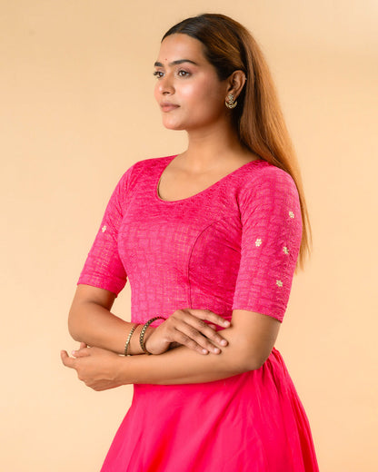 Yamini fuchsia rani blouse showing elbow sleeves with floral buti embroidery by Advi - side