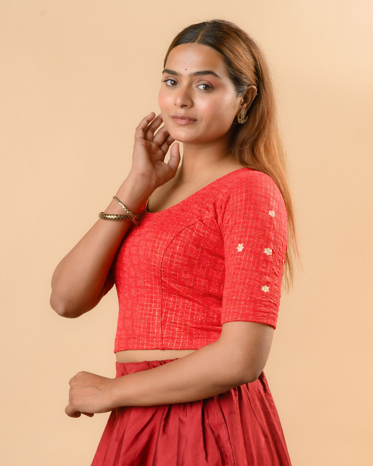 Yamini red blouse showing elbow sleeves with floral buti embroidery by Advi - side