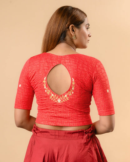 Yamini red blouse with teardrop keyhole and gold zari floral border by Advi - back