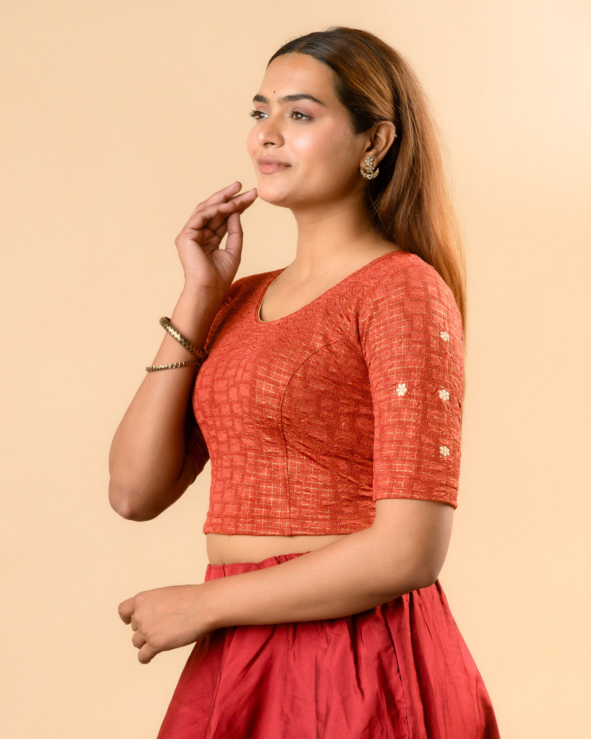 Yamini rust blouse showing elbow sleeves with floral buti embroidery by Advi - side