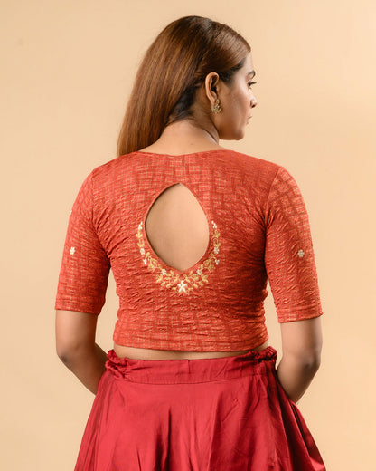Yamini rust blouse with teardrop keyhole and gold zari floral border by Advi - back