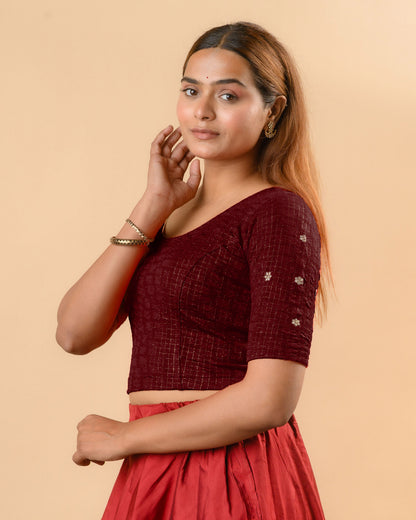 Yamini wine blouse showing elbow sleeves with floral buti embroidery by Advi - side