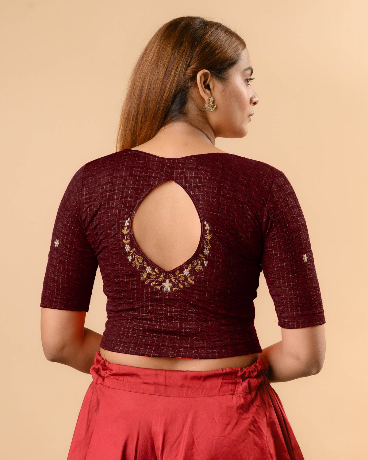 Yamini wine blouse with teardrop keyhole and gold zari floral border by Advi - back